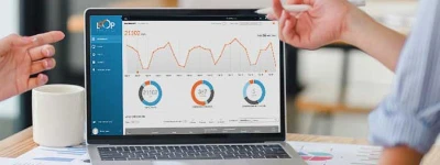 Two hands holding laptop with analytics dashboard and line graphs, the call and conversion tracking data SEO call tracking captures.