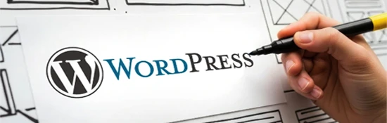 Hand drawing wireframes next to the WordPress logo for WordPress website design services